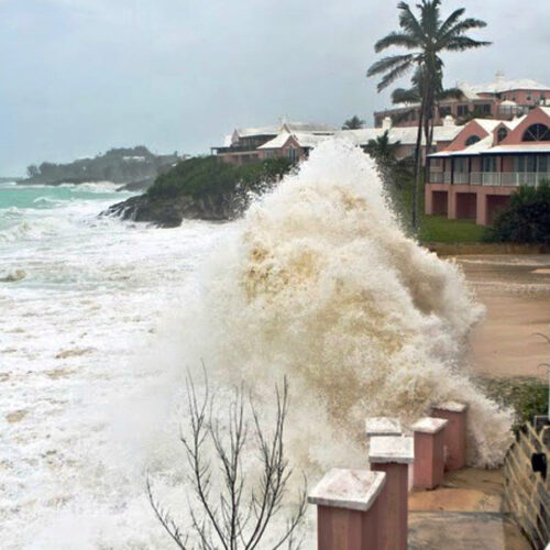 Large waves crashing against buildings