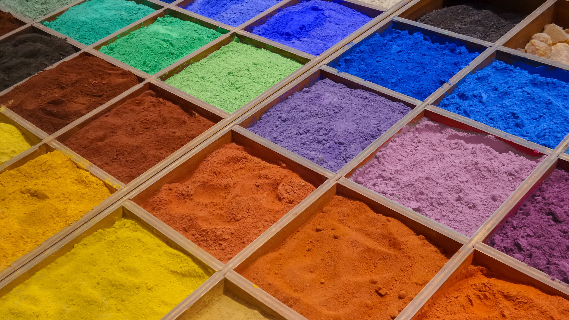 Bright, colorful pigment powders in a grid